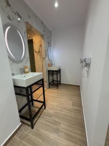 a bathroom with a sink and a mirror at Bume's Hostel in Sarandë +23 photos