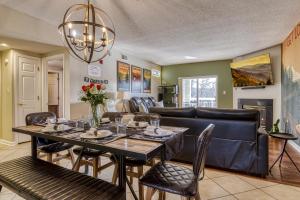 a dining room with a table and a couch at 2 King BRs Balcony Resort Amenities Free Tix in Pigeon Forge