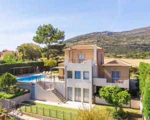 an image of a house with a swimming pool at Villa Ilias in Skala
