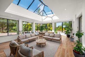 a large living room with a lot of windows at Carlogie House in Carnoustie