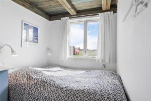 a bedroom with a bed in front of a window at LN76158-Hjorring-Bredningen-18 in Hjørring