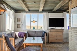 a living room with a couch and a tv at LN76158-Hjorring-Bredningen-18 in Hjørring