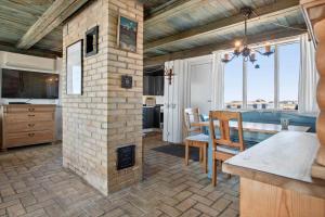 a kitchen and dining room with a brick fireplace at LN76158-Hjorring-Bredningen-18 in Hjørring +16 photos