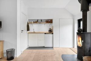 a white kitchen with a stove in a room at LN1913-Hjorring-Rubjergvej-11 in Hjørring