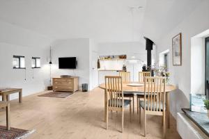 a kitchen and dining room with a table and chairs at LN1913-Hjorring-Rubjergvej-11 in Hjørring