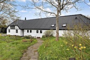 a white house with a black roof at LN1913-Hjorring-Rubjergvej-11 in Hjørring