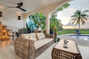 a living room with a couch and a table at Playa Potrero Beachfront Ocean Views, Pool & BBQ in Santa Cruz