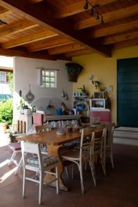 a dining room with a wooden table and chairs at Small Guesthouse in Bussolengo