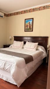 a bedroom with a large bed with two pillows at Mercedes Park Hotel in Villa Mercedes +36 photos
