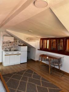 a kitchen with a table in the middle of a room at Studios Jacobus in Korčula