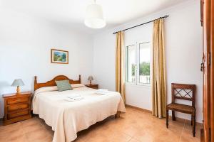 a bedroom with a bed and a window at Villa Son Domingo by Villa Select in Alaior +24 photos