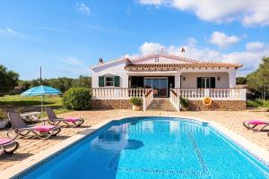 a villa with a swimming pool in front of a house at Villa Son Domingo by Villa Select in Alaior