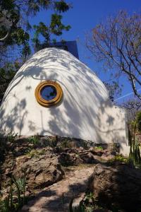 a large white dome with a clock in it at Domo Abitare Glamping in Isla de Mezcala +14 photos