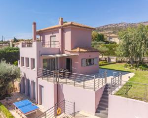 a house with a balcony and a swimming pool at Villa Anna by Villa Select in Skala