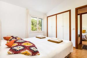 a white bedroom with a large bed with two pillows at Estrella Del Mar with Private Pool in Binibeca +19 photos