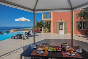 a table with a tray of food on top of a house at Lourdas Beach View by Villa Select in Lourdata