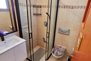 a bathroom with a shower and a sink at shohamseaview in Eilat +12 photos