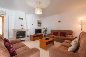 a living room with two couches and a tv at Villa Fatima by Villa Select in Galé
