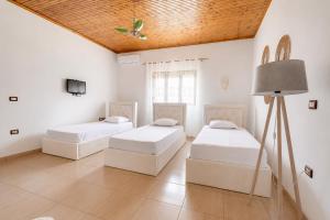 a room with two beds and a lamp in it at Villa Kevin in Berat