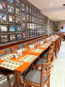 a row of tables in a restaurant with pictures on the walls at Mercedes Park Hotel in Villa Mercedes