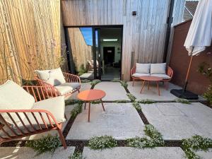 a patio with two chairs and a table at Ferox Stay in Varsenare