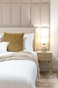 a bedroom with a bed and a table with a lamp at Splash & Relax Games WiFi BBQ Fire Pit Boat Lake in Royal Palm Beach