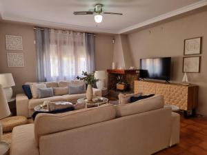 a living room with couches and a flat screen tv at MD Villa con piscina en Mareny Beach in Mareny Blau
