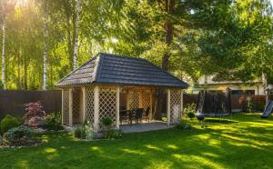 a gazebo in the yard of a home at Leśny Apartament I in Szczytno