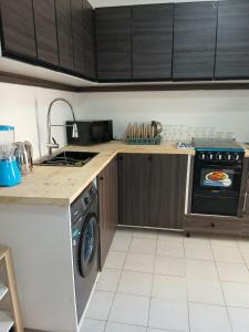 a kitchen with a stove and a dishwasher at L'hospitalité in Thies