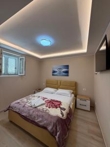 a bedroom with a large bed in a room at Alea Home in Fier