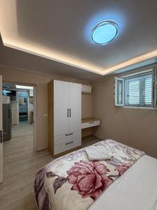 a bedroom with a large bed with a white cabinet at Alea Home in Fier