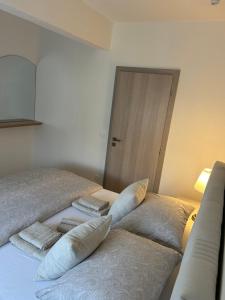 a bedroom with a bed with pillows on it at Apartman LaVida in Kaštela