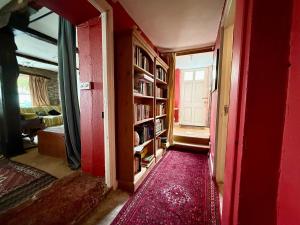 a red room with a red door and a red rug at Half Moon House in Hay-on-Wye +9 photos