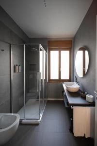 a bathroom with two sinks and a shower at Small Guesthouse in Bussolengo +42 photos