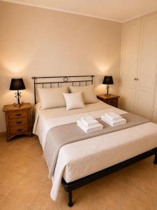 a bedroom with a large bed with two night stands at Villa Fabi in Brindisi