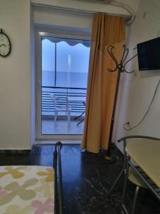 a room with a window with a view of the ocean at Calma2 in Agioi Theodoroi +4 photos