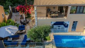 an aerial view of a house with a swimming pool at Olive & Wave Cottage in Karousádes