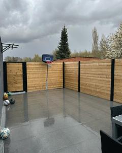 a basketball hoop on top of a wooden fence at Jimy Hendrickx in Boom