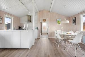 a kitchen and dining room with a table and chairs at LN2048-Hjorring-Havmanden-6 in Kærsgård Strand