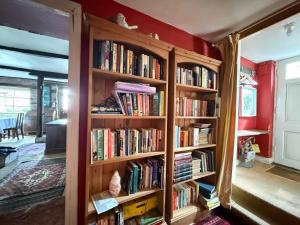 a room with book shelves filled with books at Half Moon House in Hay-on-Wye