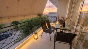 a balcony with a table and chairs on a balcony at Kalamata Deluxe Suite By AGGELOS in Kalamata