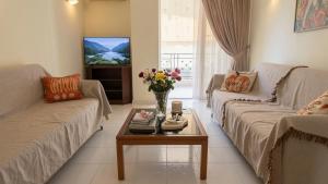 a living room with two couches and a coffee table at Kalamata Deluxe Suite By AGGELOS in Kalamata