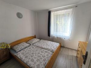 a bedroom with a bed and a window at Vila v Podkrušnohoří in Jirkov