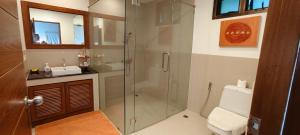 a bathroom with a shower with a sink and a toilet at Unique panoramic sea view pool villas in Phuket +41 photos