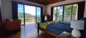 a bedroom with a bed with a view of the ocean at Unique panoramic sea view pool villas in Phuket