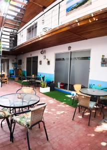 a patio with tables and chairs in a building at Ocean Lovers Taganga - PADI Dive Center & Hostel in Taganga