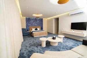 a hotel room with a bed and a tv at Twelve Hotel in Baghdād