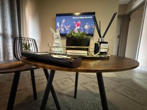 a table with a remote control on top of it at Zoe in Centurion
