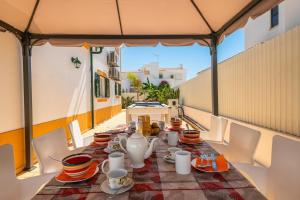 a table with a tea set on a balcony at Villa Fatima by Villa Select in Galé
