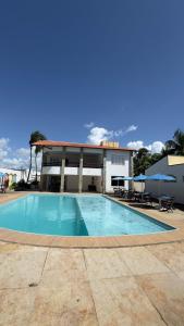 a large swimming pool in front of a building at Pousada Holy Salt Cumbuco in Caucaia +8 photos